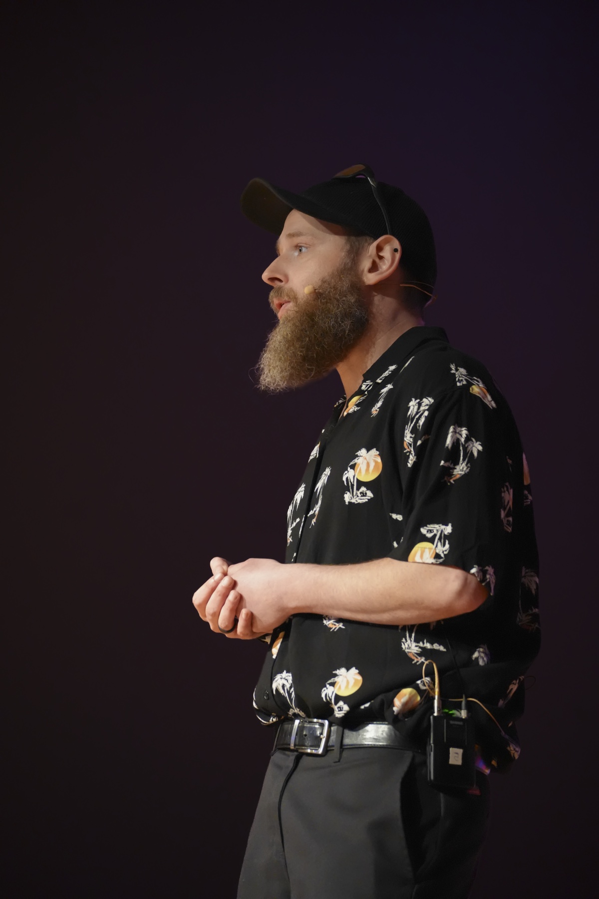 George Whitcher speaking to a live audience on stage