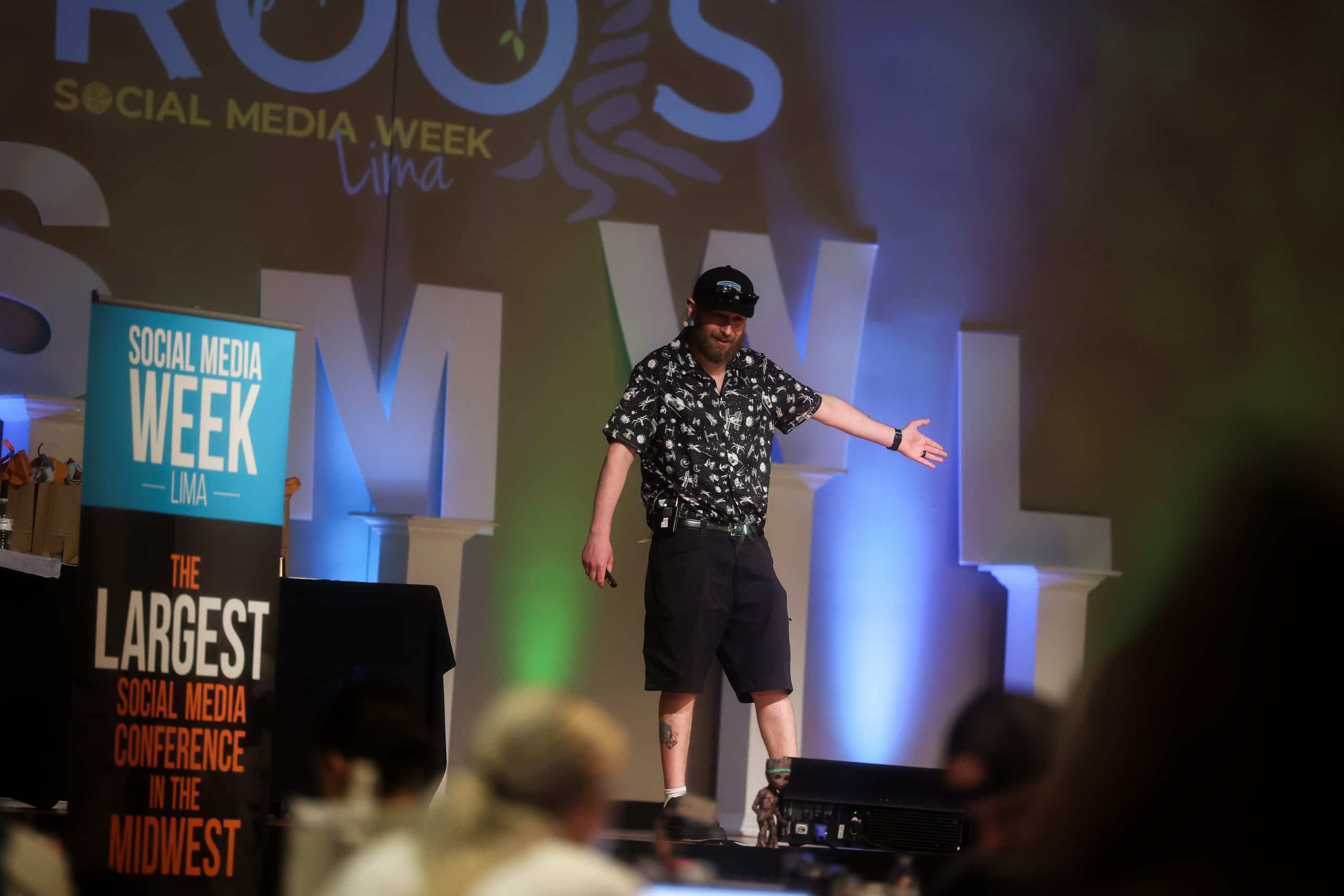 George gesturing as he presents to the audience